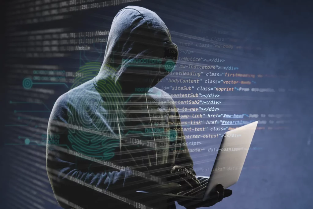 image of a hacker with a laptop, hacked website repair services by uniweb